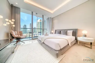 a bedroom with a large bed and a large window at Plush Studio at The Sterling East House Business Bay by Deluxe Holiday Homes in Dubai