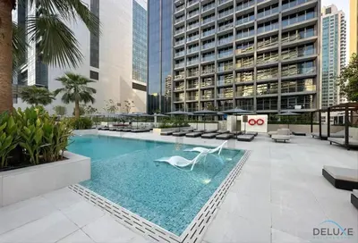 a swimming pool in the middle of a building at Plush Studio at The Sterling East House Business Bay by Deluxe Holiday Homes in Dubai