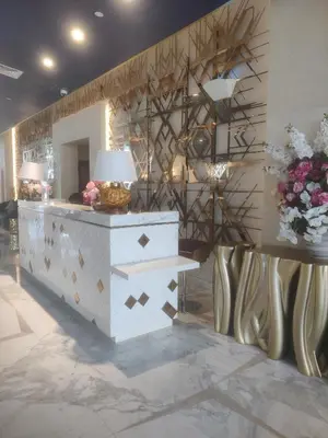 a lobby with a desk with a lamp and flowers at LeModCasa - Luxury smart Studio with Canal View Business Bay in Dubai