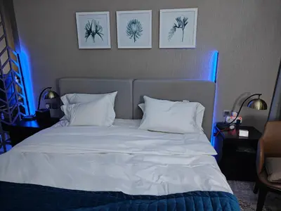 a bedroom with a white bed with blue lights at LeModCasa - Luxury smart Studio with Canal View Business Bay in Dubai
