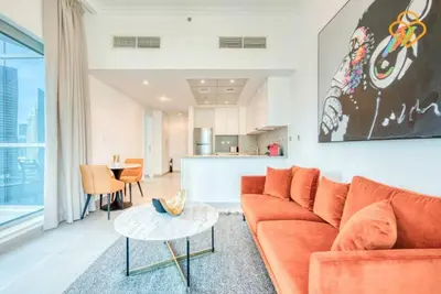 a living room with a orange couch and a table at Keysplease Magnificent views of the Marina, Bay Central Dubai Marina in Dubai