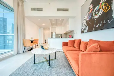 a living room with an orange couch and a table at Keysplease Magnificent views of the Marina, Bay Central Dubai Marina in Dubai