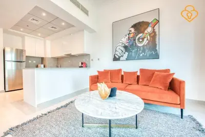 a living room with a red couch and a table at Keysplease Magnificent views of the Marina, Bay Central Dubai Marina in Dubai