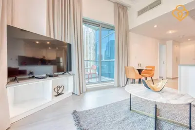 a living room with a table and a large window at Keysplease Magnificent views of the Marina, Bay Central Dubai Marina in Dubai