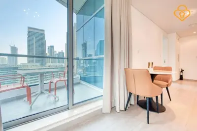 a room with a table and chairs and a large window at Keysplease Magnificent views of the Marina, Bay Central Dubai Marina in Dubai
