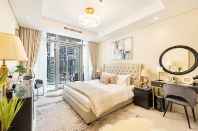 a bedroom with a bed and a desk and a mirror at Stylish 2BR at Paramount Hotel Midtown in Dubai