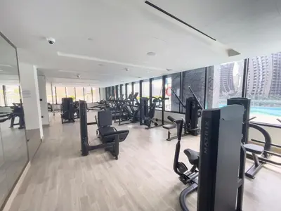 a gym with a lot of treadmills and exercise bikes at Elegant treat with Burj Khalifa view by Suiteable in Dubai