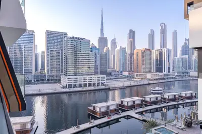 a view of a city with a river and buildings at Elegant treat with Burj Khalifa view by Suiteable in Dubai