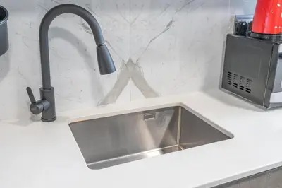 a kitchen counter with a sink and aaucet at Modern Comfort in a Spacious Apartment - Suiteable in Dubai