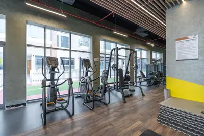 a gym with several treadmills and elliptical machines at Modern Comfort in a Spacious Apartment - Suiteable in Dubai