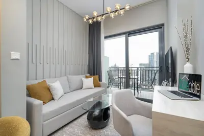 a living room with a couch and a table at Serenity in Style in Zada Residence by Suiteable in Dubai