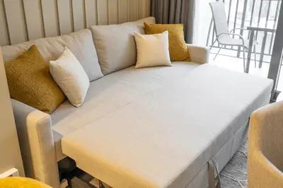 a white couch with pillows in a living room at Serenity in Style in Zada Residence by Suiteable in Dubai