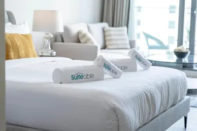 a white bed with three pillows on top of it at Dive into Luxury at LIV Residence - Suiteable in Dubai