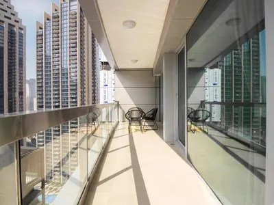 an empty balcony in a building with chairs at Downtown Chic Easy walk to Dubai Mall & Fountain in Dubai