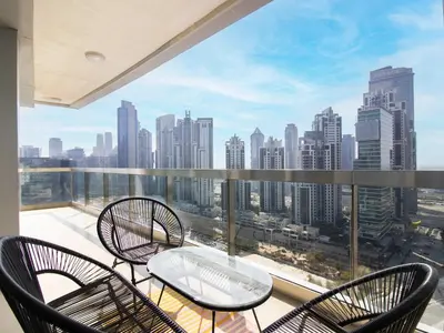 a balcony with chairs and a table and a view of the city at Downtown Chic Easy walk to Dubai Mall & Fountain in Dubai