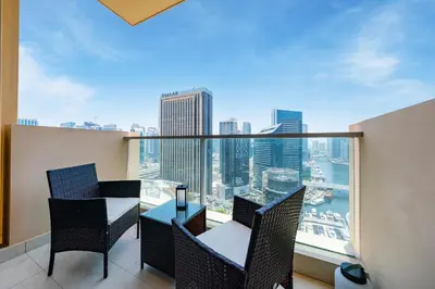a balcony with a table and chairs and a view of the city at Luxury Studio with Stunning Marina & Beach Views in Dubai