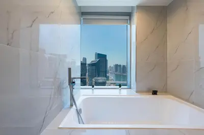 a bathroom with a tub with a view of the city at Luxury Studio with Stunning Marina & Beach Views in Dubai