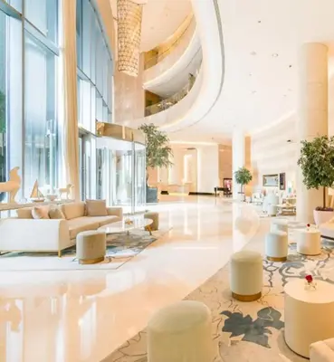 a lobby with couches and tables in a building at Luxury Studio with Stunning Marina & Beach Views in Dubai