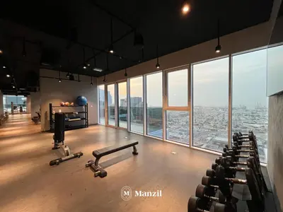an empty gym with a view of a city at Manzil - 2BR Apt in Al Wasl Residences with Park View, Dubai Trade Center in Dubai