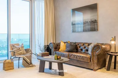 a living room with a leather couch and a table at Manzil - 2BR Apt in Al Wasl Residences with Park View, Dubai Trade Center in Dubai