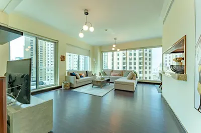 a living room with a couch and a tv at Dubai Marina Apartment with Sea view, Pool and Gym in Dubai
