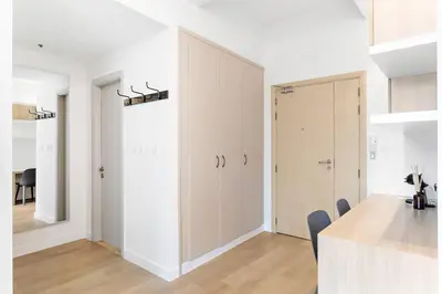 a kitchen with white walls and a large sliding door at Tranquil Dubai Marina Studio by JBR Beach, Marina Mall, Metro in Dubai