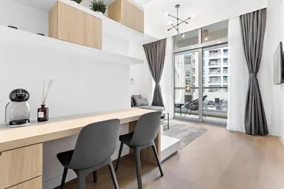 a kitchen with a desk and chairs in a room at Tranquil Dubai Marina Studio by JBR Beach, Marina Mall, Metro in Dubai