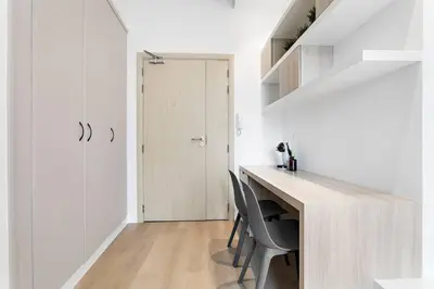 a white room with a desk and a door at Tranquil Dubai Marina Studio by JBR Beach, Marina Mall, Metro in Dubai