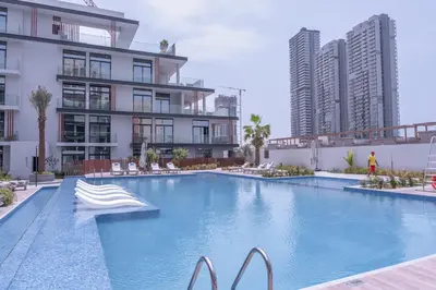 a large swimming pool in front of a building at New Listing - TOP Amenities in JVC in Dubai