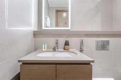 a bathroom with a sink and a mirror at STAY BY LATINEM Luxury 2BR Holiday Home W1504 near Burj Khalifa in Dubai