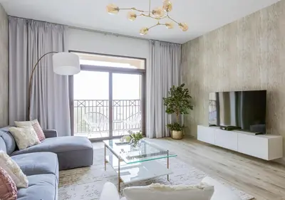 a living room with a couch and a tv at Nasma Luxury Stays - Fabulous Apartment With Balcony Near MJL's Souk in Dubai