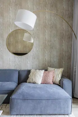 a blue couch in a living room with a mirror at Nasma Luxury Stays - Fabulous Apartment With Balcony Near MJL's Souk in Dubai