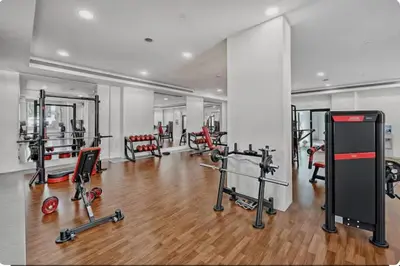 a gym with lots of equipment in a room at Nasma Luxury Stays - Fabulous Apartment With Balcony Near MJL's Souk in Dubai