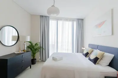 a bedroom with a large bed and a mirror at 1BR •The Address Beach Residence - High floor in Dubai