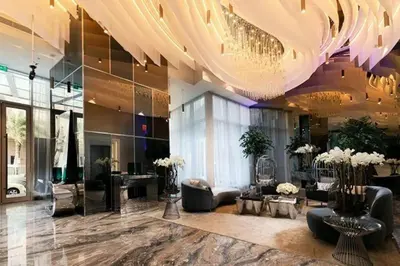 a lobby with a large chandelier and a salon at Fantastic View l Great Amenities l Superb Location in Dubai