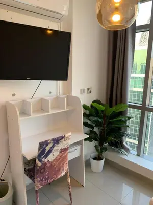 a room with a desk with a tv and a chair at Coliving Sharing Hostel ll in Dubai