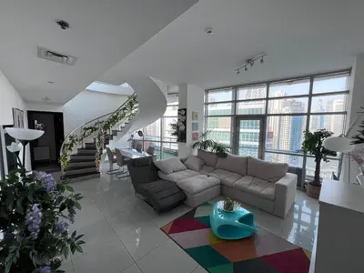 a living room with a couch and a table at Coliving Sharing Hostel ll in Dubai