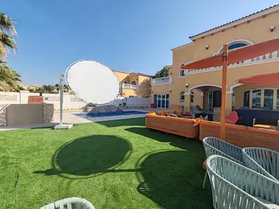 a yard with a large mirror on the side of a house at Royal private pool, Lux 7-bedroom villa on Marina in Dubai