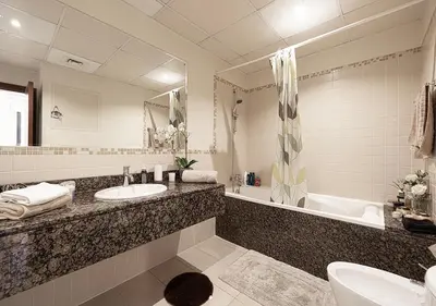 a bathroom with a sink and a tub and a mirror at First Class Apartments in Heart of JBR, Steps to the Beach - 121 Living in Dubai