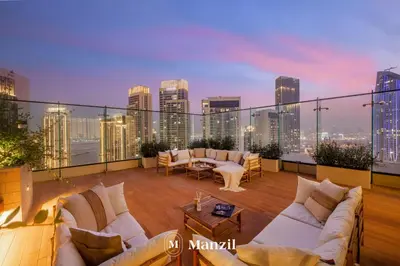 a balcony with couches and a view of the city at Manzil - Luxury 4BR Penthouse with Harbour View & Private Terrace at Dubai Creek Harbour in Dubai