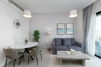 a living room with a blue couch and a table at Address JBR Marina View, Jumeirah Beach Residence, Dubai Marina - Mint Stay in Dubai