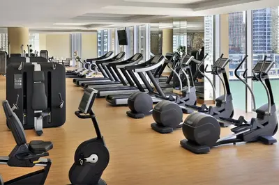a gym with a lot of treadmills and machines at Emaar Marina Residences - formerly Address Dubai Marina in Dubai