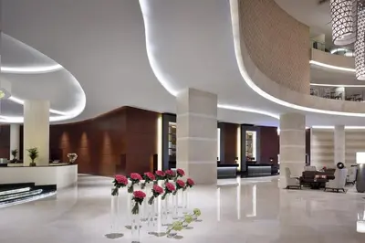 a lobby with red roses in vases on the floor at Emaar Marina Residences - formerly Address Dubai Marina in Dubai