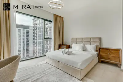 a bedroom with a bed and a large window at Mira Holiday Homes - Fully furnished 2 bedroom in Dubai Hills in Dubai