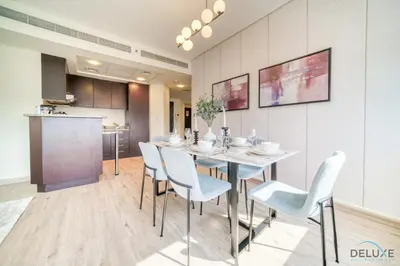 a dining room with a table and chairs at Gleeful 2BR at Sky Gardens DIFC by Deluxe Holiday Homes in Dubai