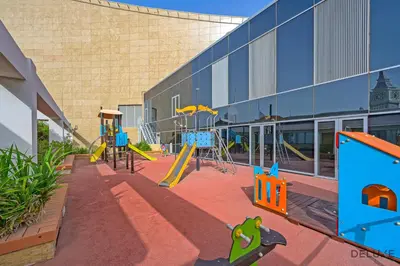 an empty playground in front of a building at Amazing 2BR at Sky Gardens DIFC by Deluxe Holiday Homes in Dubai