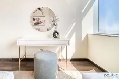a white desk with a mirror and a chair at Amazing 2BR at Sky Gardens DIFC by Deluxe Holiday Homes in Dubai