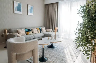a living room with a couch and a table at Luxury Dubai Creek Balcony & View in Dubai