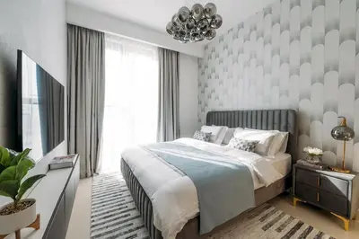 a bedroom with a bed and a large window at Luxury Dubai Creek Balcony & View in Dubai