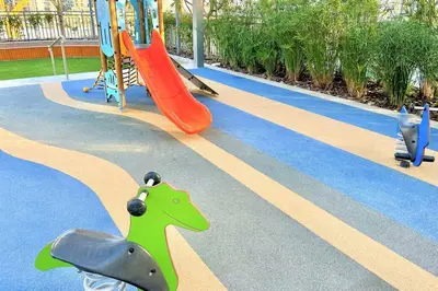 a playground with a slide and a dinosaur and slides at Luxury Dubai Creek Balcony & View in Dubai